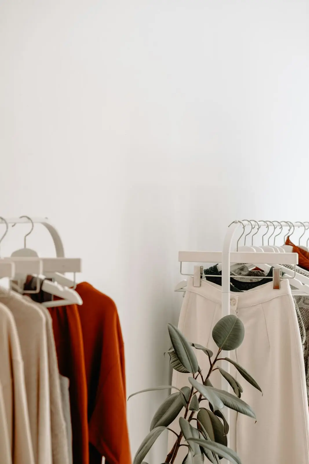 A boutique rack of neutral-toned garments