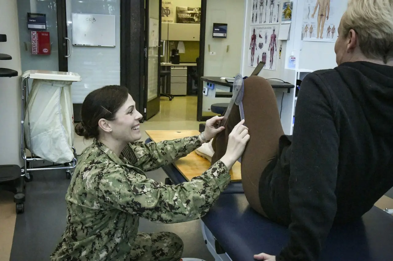 A physical therapist checking a patient's flexibility