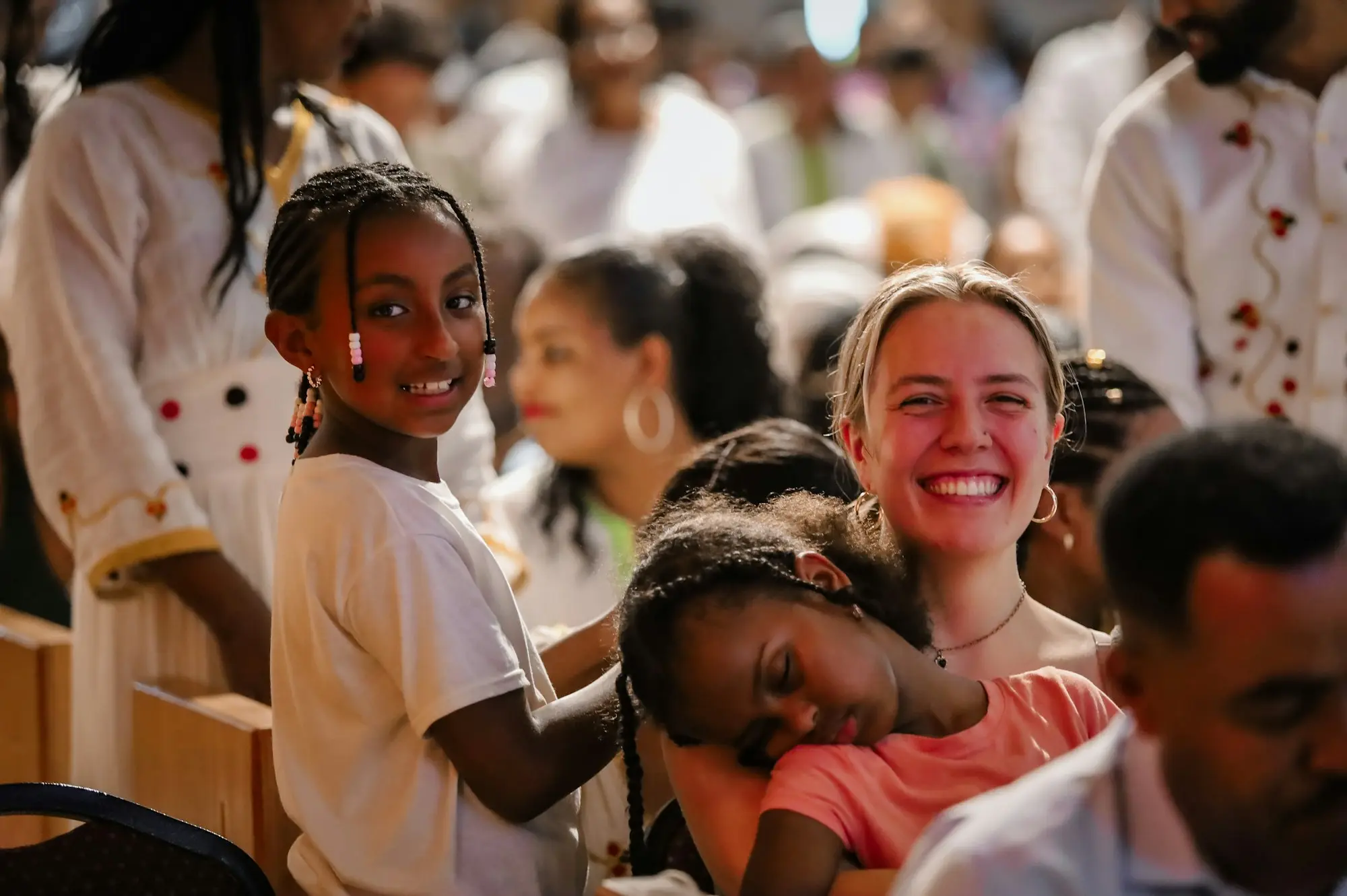 A congregation smiling and laughing together during a service