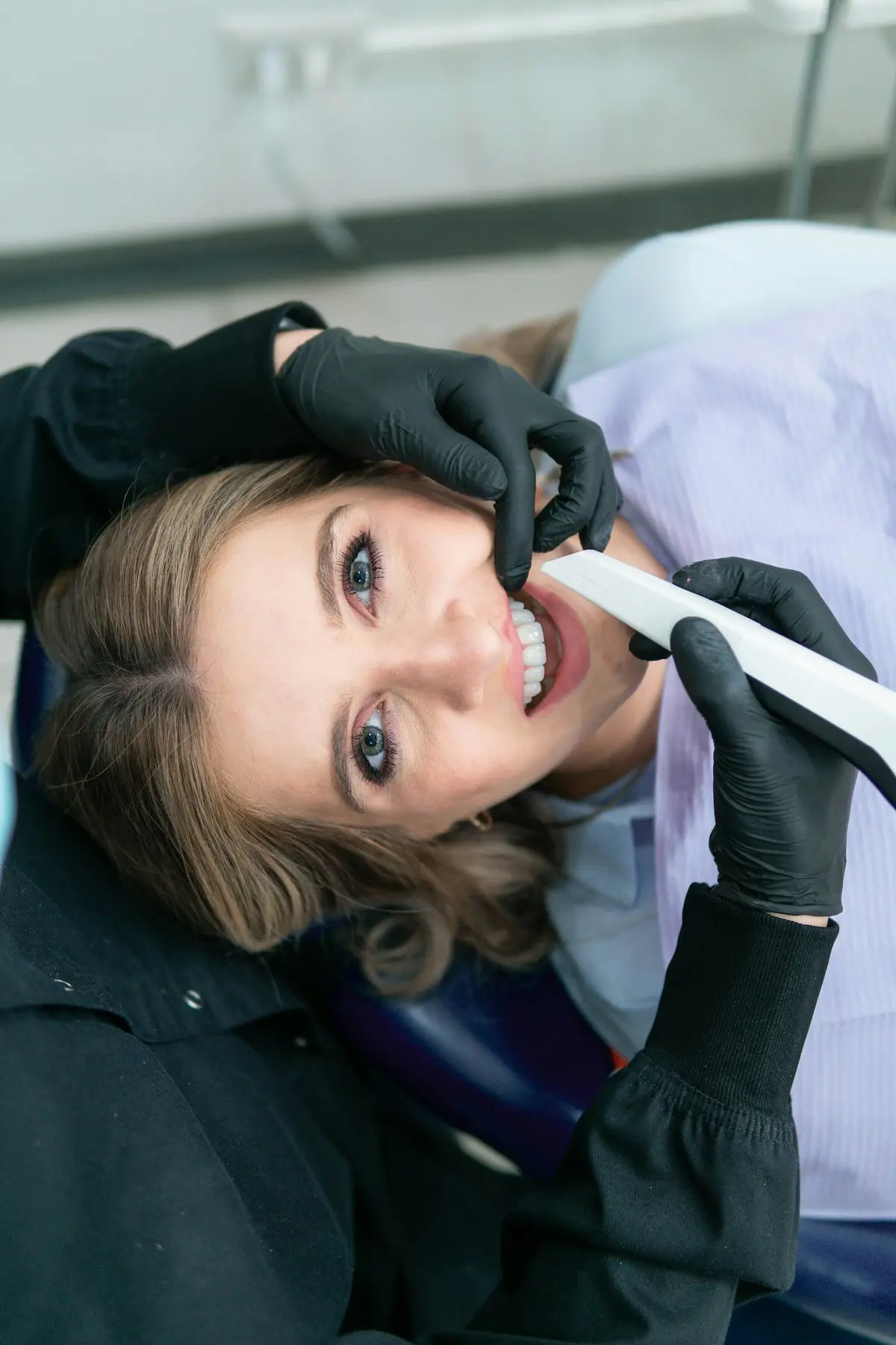 A woman smiling while holding a toothbrush