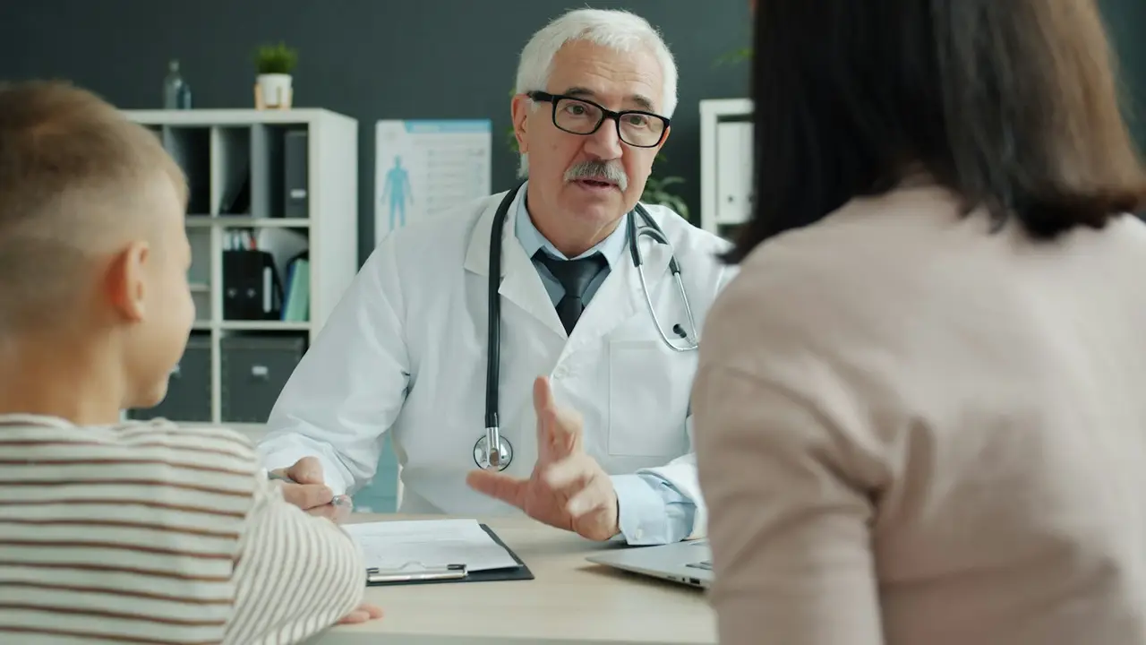 A doctor talking with a mother and her child
