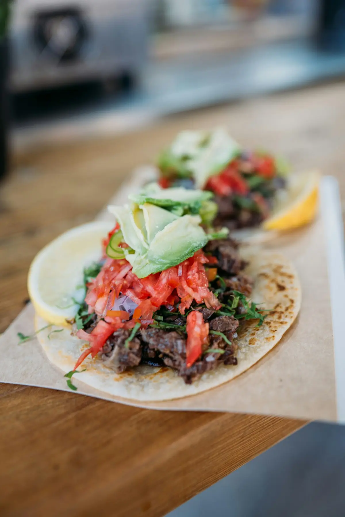 A street taco with salsa and avocado