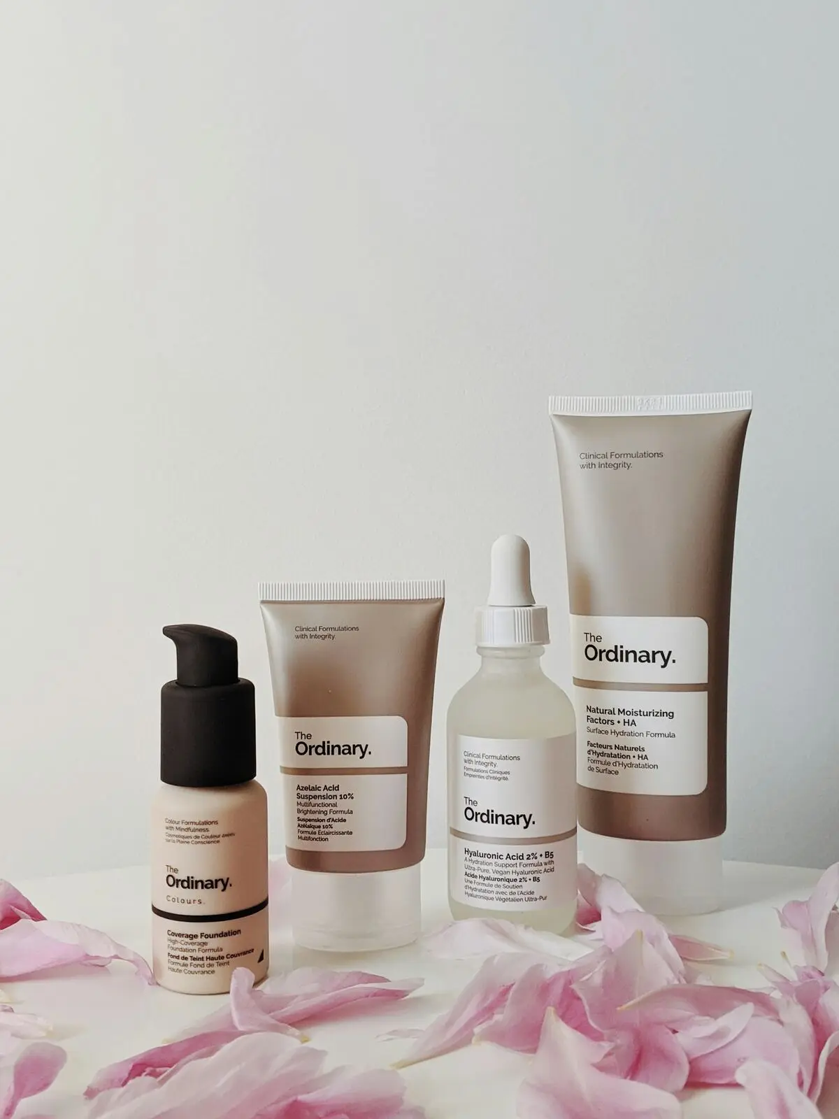 Skincare products arranged with petals